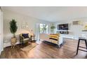 Well-lit living room featuring a sliding glass door to a balcony at 937 N Clarkson St # 405, Denver, CO 80218