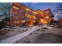 Inviting courtyard featuring decorative stone pavers, fountain, and mature landscaping at 20 S Logan St # 104, Denver, CO 80209