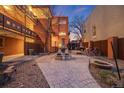 Serene courtyard featuring a decorative fountain, manicured gravel beds, and stone pavers at 20 S Logan St # 104, Denver, CO 80209