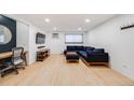 Comfortable living room with hardwood floors, sectional sofa, and desk at 20 S Logan St # 104, Denver, CO 80209