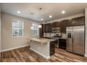 Modern kitchen featuring dark cabinetry, granite countertops, and stainless steel appliances at 630 E Hinsdale Ave, Littleton, CO 80122