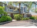 Charming townhome with a brick facade, balcony, and well-maintained landscaping in a tranquil setting at 6810 E Appleton Ct, Centennial, CO 80112