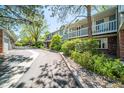 A quiet street view of townhomes, showcasing well-maintained exteriors, balconies, and mature trees at 6810 E Appleton Ct, Centennial, CO 80112