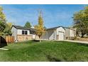 House with a nicely landscaped lawn and driveway at 17769 E Purdue Pl, Aurora, CO 80013