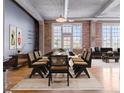 Open dining area with modern table set, exposed brick walls, and abundant natural light at 1301 Wazee St # 2D, Denver, CO 80204