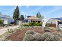 Inviting property with mature landscaping and a bright yellow front door at 3941 S Elati St, Englewood, CO 80110