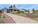 Inviting property with mature landscaping and a long private driveway at 3941 S Elati St, Englewood, CO 80110