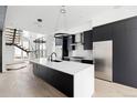 Elegant kitchen featuring a spacious island, stainless steel appliances, and modern lighting fixtures at 5258 Lions Paw St, Castle Rock, CO 80104