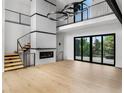 Bright living room boasts a cozy fireplace and large sliding doors offering an expansive view at 5258 Lions Paw St, Castle Rock, CO 80104