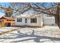 Charming home featuring a quaint front exterior with a walkway and snowy yard at 4100 Fenton St, Denver, CO 80212