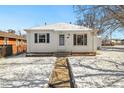 Charming home featuring a quaint front exterior with a walkway and snowy yard at 4100 Fenton St, Denver, CO 80212