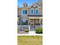 Inviting townhome with a cozy front porch, complemented by a white picket fence at 16285 W 62Nd Ln # C, Arvada, CO 80403
