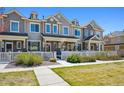 Attractive townhome featuring a landscaped front yard and charming white picket fence at 16285 W 62Nd Ln # C, Arvada, CO 80403