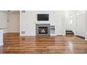 Spacious living room with a modern fireplace and stylish wood flooring at 16285 W 62Nd Ln # C, Arvada, CO 80403