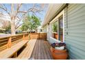 Spacious wooden deck featuring a built-in bench and vibrant potted flowers, perfect for outdoor relaxation at 1662 S Eudora St, Denver, CO 80222