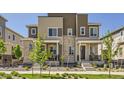 Charming townhome with neutral siding, brick accents, inviting front porches, and well-maintained landscaping at 24374 E 42Nd Ave, Aurora, CO 80019