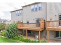 Spacious backyard featuring a private wooden deck, mature landscaping, and room for outdoor activities at 992 Burning Bush Pt, Monument, CO 80132
