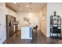 Modern kitchen boasts stainless steel appliances, stone countertops, and a breakfast bar with stylish seating at 15476 W 64Th Loop # C, Arvada, CO 80007