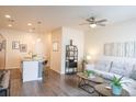 Comfortable living room featuring modern furniture, a ceiling fan, and a stylish breakfast bar at 15476 W 64Th Loop # C, Arvada, CO 80007