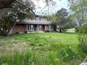Traditional two-story brick house with bright windows and a sprawling lawn at 7583 W Trail South Dr, Littleton, CO 80125