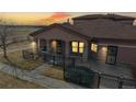 Beautiful exterior view of the home featuring warm stucco siding, a covered porch and a dark roof at 15501 E 112Th Ave # 30A, Commerce City, CO 80022