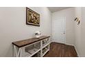 Inviting entryway with beautiful wood floors and a stylish console table with decor at 1836 Taos St, Brighton, CO 80603