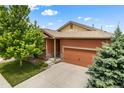 Well-maintained home featuring stone accents, mature landscaping and a spacious driveway at 1836 Taos St, Brighton, CO 80603