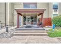 Condo building entrance with awning and seating at 2231 S Vaughn Way # 305B, Aurora, CO 80014