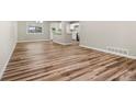 Open-concept living space with hardwood floors, neutral paint, and bright kitchen area at 1179 Salem St, Aurora, CO 80011