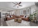 Open-concept living room with hardwood floors, neutral paint, and lots of natural light at 12510 Fisher St, Englewood, CO 80112