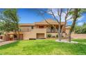 A charming two-story home boasts a spacious backyard with lush greenery and mature trees at 6201 Rain Dance Trl, Littleton, CO 80125