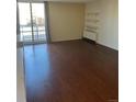 This living room features hardwood floors, and large windows with a sliding glass door at 2500 S York St # 401, Denver, CO 80210
