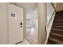 Inviting foyer with white front door, tiled entryway and wood-look flooring at 7995 E Mississippi Ave # 24, Denver, CO 80247