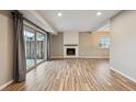 Spacious living room featuring a fireplace, sliding glass doors and wood-look floors at 7995 E Mississippi Ave # 24, Denver, CO 80247