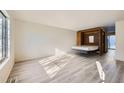 Bedroom with a wall bed, light walls, and wood-look floors at 61 S Sable Blvd # C14, Aurora, CO 80012