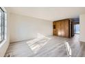 Bright living room with wood-look floors and built-in storage at 61 S Sable Blvd # C14, Aurora, CO 80012