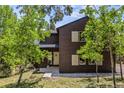 Charming two-story home with wood siding, lush landscaping, and a welcoming front entrance at 30866 Kings Valley Way, Conifer, CO 80433