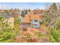 Backyard aerial view of home featuring an expansive pergola, patio, and mature landscaping at 12718 W 84Th Dr, Arvada, CO 80005