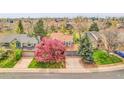 An aerial view of the home and its well-maintained landscaping in a quiet neighborhood at 12718 W 84Th Dr, Arvada, CO 80005
