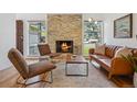 Cozy living room with stone fireplace, hardwood floors, and comfortable seating at 7910 Hooker St, Westminster, CO 80030