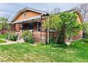 Lovely home with a brick exterior, green lawn and appealing front garden at 767 S York St, Denver, CO 80209