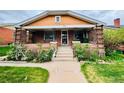 Inviting home entrance featuring a brick facade and well maintained steps at 767 S York St, Denver, CO 80209