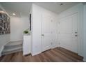 Bright entryway with wood-look flooring, white walls, and access to the staircase at 13545 E 103Rd Ave, Commerce City, CO 80022