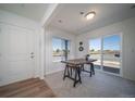 Sunlit office featuring a wooden desk, a large window, and sliding glass door access at 13545 E 103Rd Ave, Commerce City, CO 80022