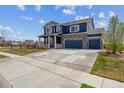 Two-story home with a three-car garage, spacious driveway and inviting curb appeal at 7498 E 157Th Pl, Thornton, CO 80602