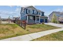 Lovely two-story home with a well-maintained lawn, fenced yard, and inviting curb appeal at 7498 E 157Th Pl, Thornton, CO 80602