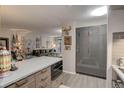 Open concept kitchen with gray cabinets, stainless steel appliances, and view to the living room at 2 Adams St # 809, Denver, CO 80206