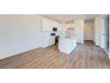 Bright kitchen features stainless steel appliances, white cabinets, and a center island with a sink at 1280 S Algonquian St, Aurora, CO 80018