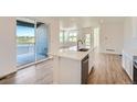 Modern kitchen features white cabinetry, stainless steel appliances and sliding glass door to deck at 1280 S Algonquian St, Aurora, CO 80018