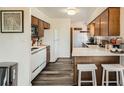 Bright kitchen with wooden cabinets, white appliances, modern countertops and bar stool seating at 28669 Mountain View Rd, Conifer, CO 80433